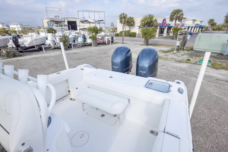 Slide: The Image of 2016 Sea Hunt Gamefish 25 boat with dual engines in a marina setting. - 14