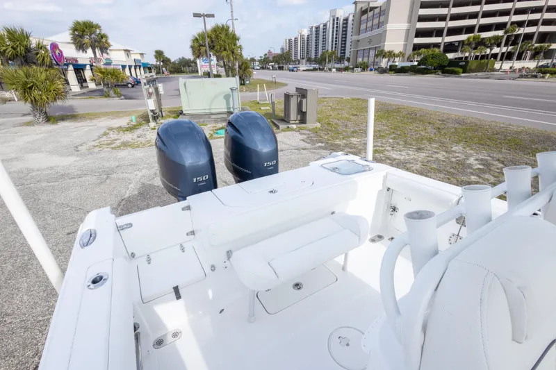 Slide: The Image of 2016 Sea Hunt Gamefish 25 boat with dual 150 engines, parked near a street. - 15