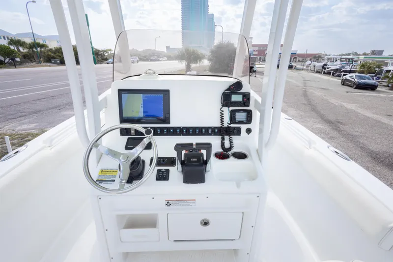 Slide: The Image of 2016 Sea Hunt Gamefish 25 helm with navigation equipment and steering wheel. - 17