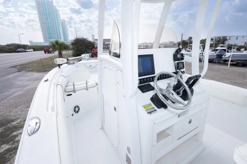 Slide: The Image of 2016 Sea Hunt Gamefish 25 boat interior with steering console and navigation equipment. - 18