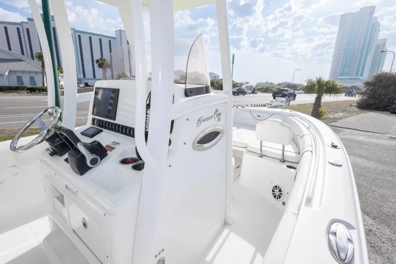 Slide: The Image of 2016 Sea Hunt Gamefish 25 boat interior with modern controls and seating. - 22