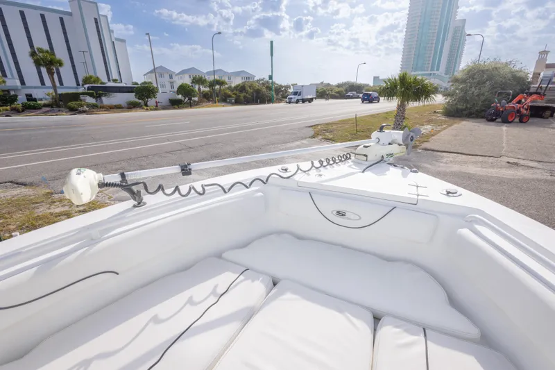 Slide: The Image of 2016 Sea Hunt Gamefish 25 boat on a sunny street near buildings and palm trees. - 23