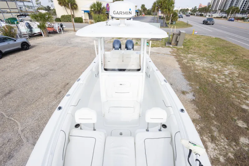 Slide: The Image of 2016 Sea Hunt Gamefish 25 boat with Garmin equipment, parked on a roadside. - 25
