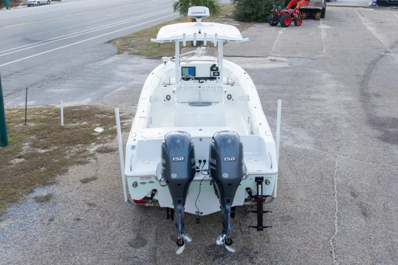 Slide: The Image of 2016 Sea Hunt Gamefish 25 boat with dual Yamaha 150 engines, parked on pavement. - 30