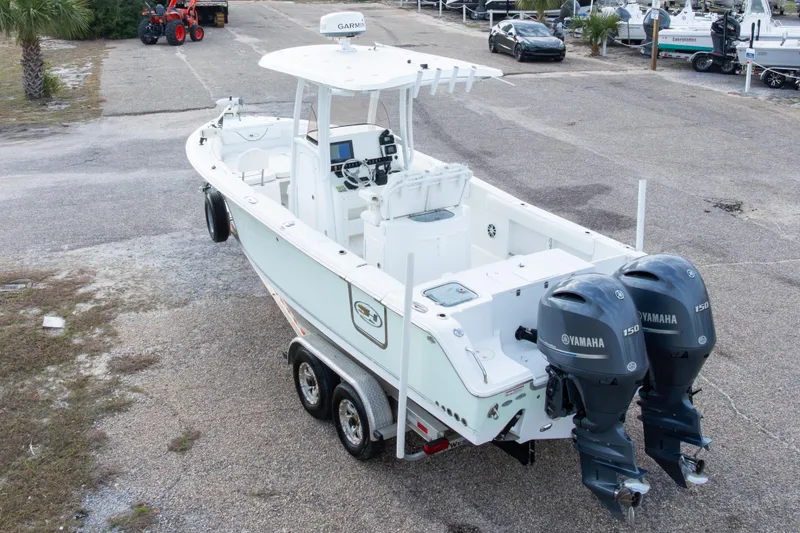 Slide: The Image of 2016 Sea Hunt Gamefish 25 boat with dual Yamaha 150 engines on a trailer. - 31