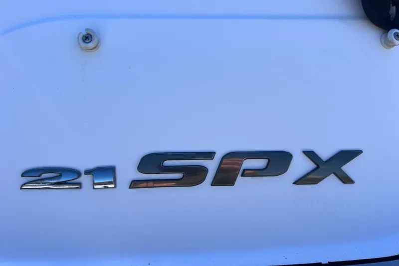 Slide: The Image of Close-up of 2015 Sea Ray 21 SPX OB model emblem on white surface. - 11