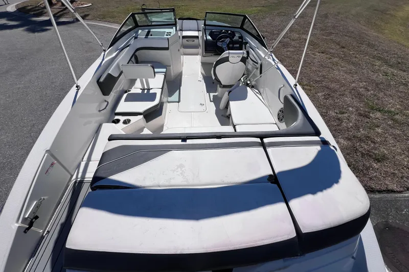 Slide: The Image of 2015 Sea Ray 21 SPX OB boat interior with seating and steering wheel. - 13