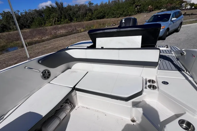 Slide: The Image of 2015 Sea Ray 21 SPX OB boat interior with seating and cup holders. - 18
