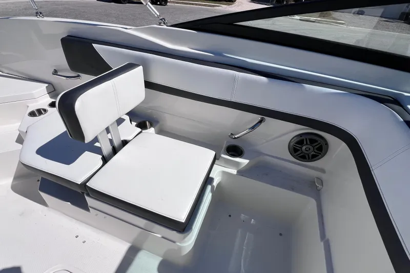 Slide: The Image of 2015 Sea Ray 21 SPX OB boat interior with white seating and cup holders. - 22
