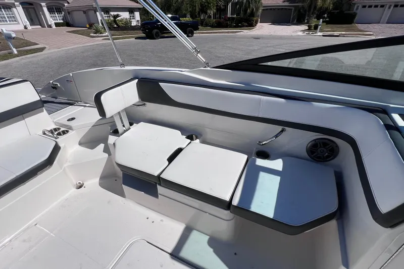 Slide: The Image of Interior seating of 2015 Sea Ray 21 SPX OB boat, featuring white and gray upholstery. - 23