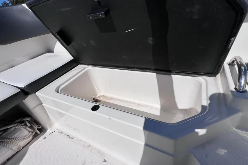 Slide: The Image of Open storage compartment on 2015 Sea Ray 21 SPX OB boat. - 25