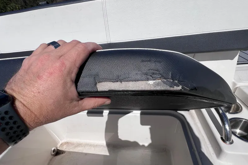 Slide: The Image of Damaged seat upholstery on 2015 Sea Ray 21 SPX OB boat, showing wear and tear. - 26