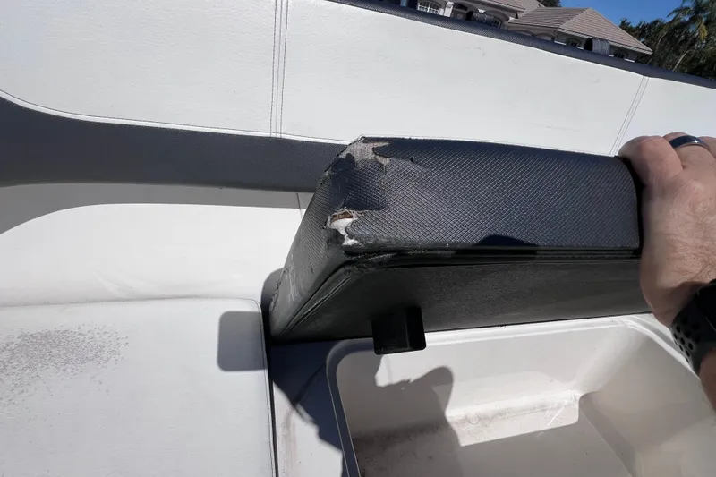 Slide: The Image of Damaged seat cushion on 2015 Sea Ray 21 SPX OB boat, showing wear and tear. - 27