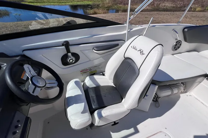 Slide: The Image of 2015 Sea Ray 21 SPX OB boat interior with steering wheel and seating. - 31