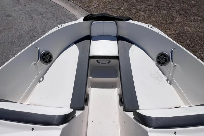 Slide: The Image of 2015 Sea Ray 21 SPX OB boat interior with cushioned seating and speakers. - 32