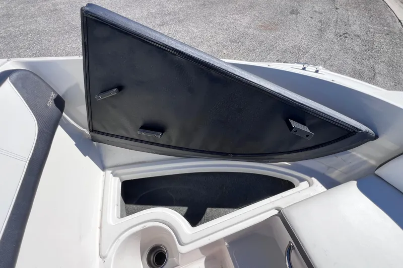 Slide: The Image of 2015 Sea Ray 21 SPX OB boat storage compartment with open hatch. - 34