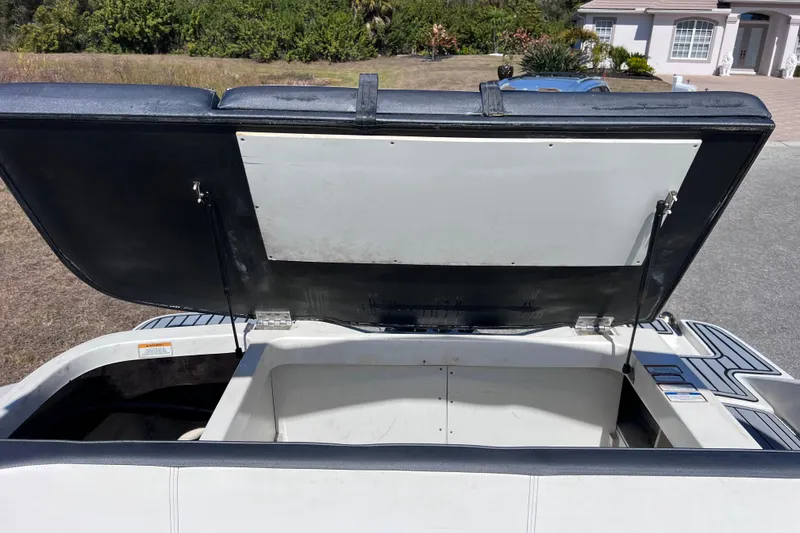 Slide: The Image of Open storage compartment of 2015 Sea Ray 21 SPX OB boat, showcasing interior space. - 39