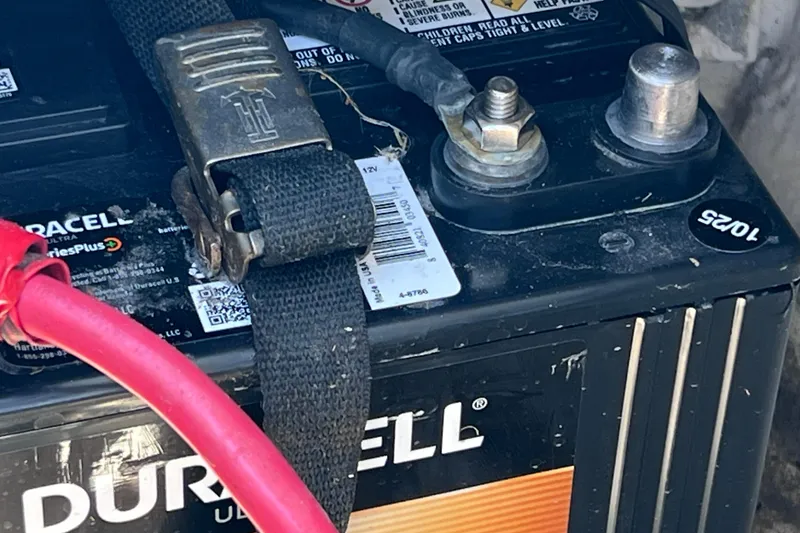 Slide: The Image of Duracell battery in a 2015 Sea Ray 21 SPX OB boat, secured with a strap. - 40