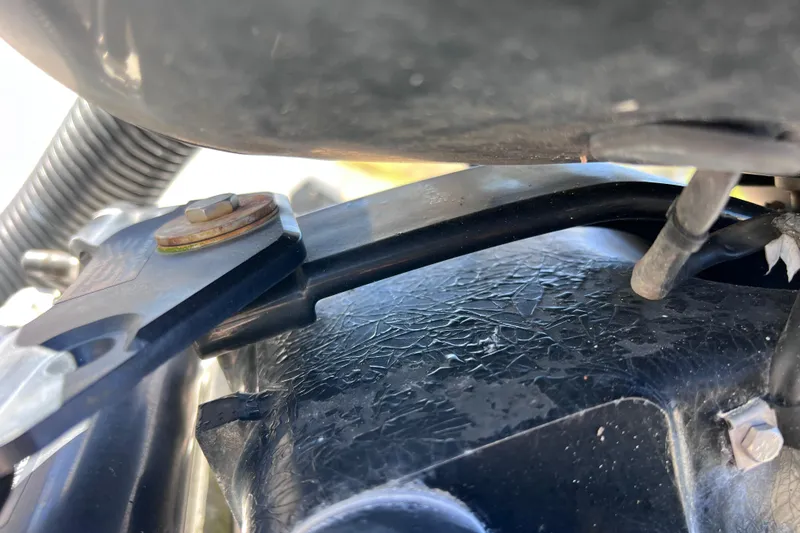 Slide: The Image of Close-up of 2015 Sea Ray 21 SPX OB engine components, showing bolts and wiring. - 49