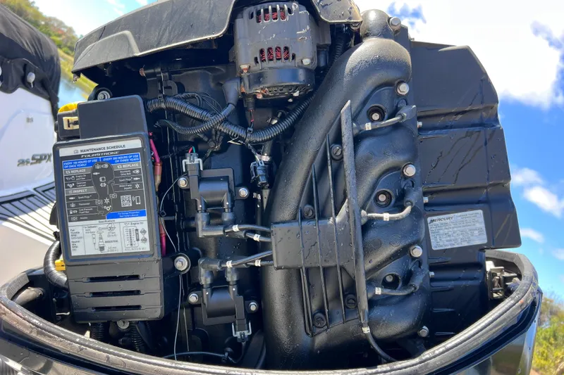 Slide: The Image of Close-up of a 2015 Sea Ray 21 SPX OB engine, showcasing detailed components and maintenance schedule. - 51