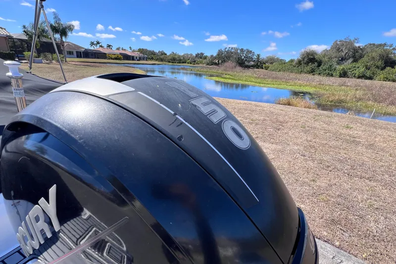 Slide: The Image of Outboard motor of a 2015 Sea Ray 21 SPX OB near a scenic lake. - 6