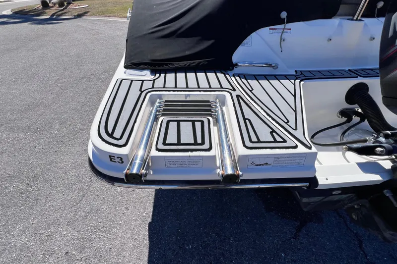 Slide: The Image of 2015 Sea Ray 21 SPX OB swim platform with retractable ladder, black and white design. - 7