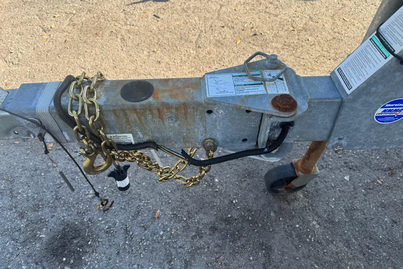 Slide: The Image of Trailer hitch of a 2018 Yamaha Boats 190 FSH Deluxe, showing chains and rust. - 14