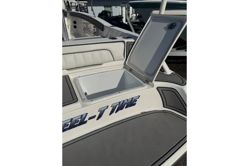 Slide: The Image of 2018 Yamaha Boats 190 FSH Deluxe with open storage compartment, showcasing sleek design. - 15