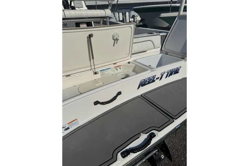 Slide: The Image of 2018 Yamaha Boats 190 FSH Deluxe with open storage compartments, labeled "Reel-T Time." - 16