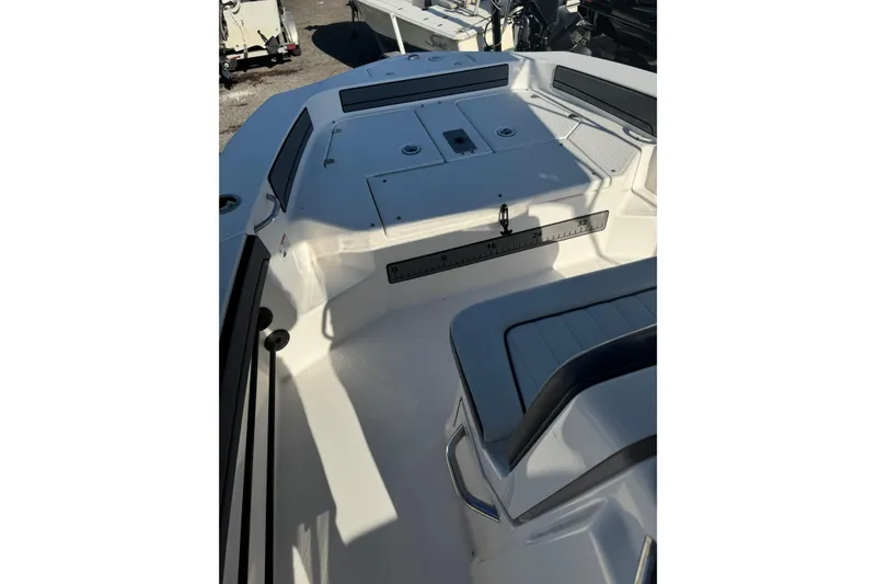 Slide: The Image of 2018 Yamaha Boats 190 FSH Deluxe interior with seating and storage compartments. - 18