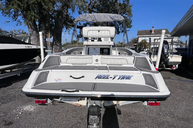 Slide: The Image of 2018 Yamaha Boats 190 FSH Deluxe, rear view, parked outdoors, showcasing sleek design. - 2
