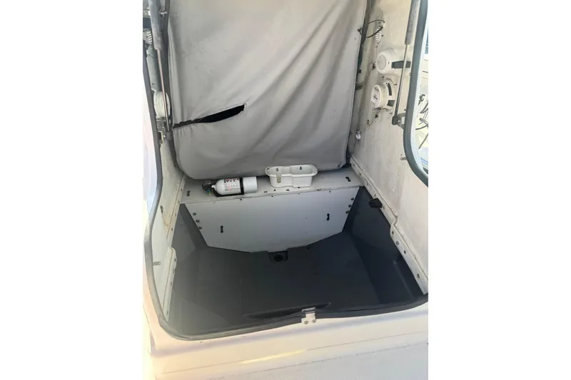 Slide: The Image of 2018 Yamaha Boats 190 FSH Deluxe interior storage compartment with fire extinguisher. - 23