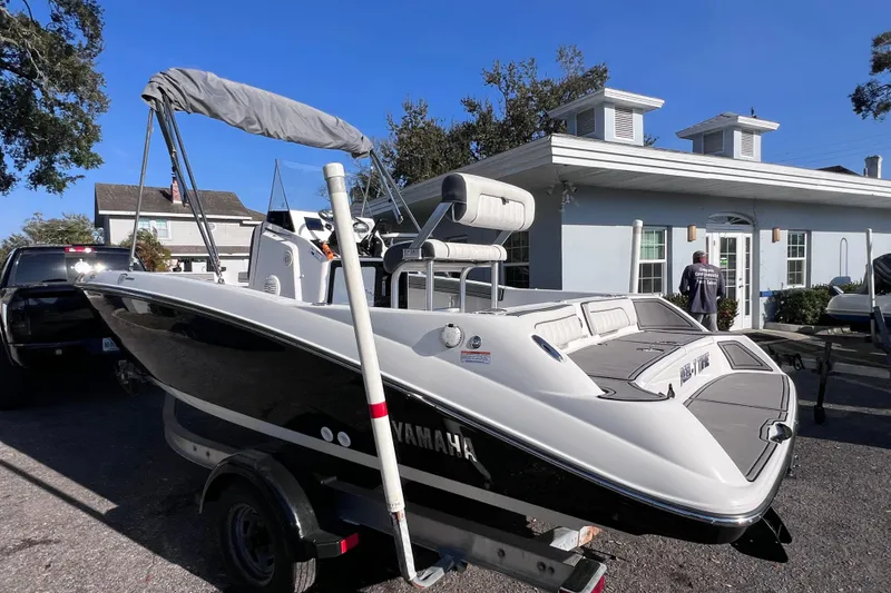 Slide: The Image of 2018 Yamaha Boats 190 FSH Deluxe on trailer, parked near a building. - 3