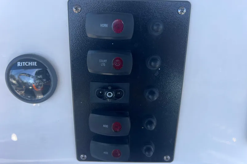 Slide: The Image of Control panel of 2018 Yamaha Boats 190 FSH Deluxe with compass and switches. - 37