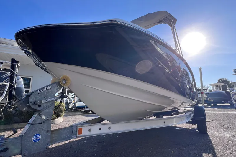 Slide: The Image of 2018 Yamaha Boats 190 FSH Deluxe on trailer under bright sun. - 7