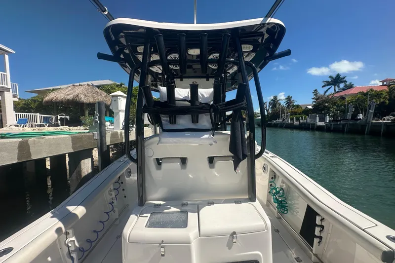 Slide: The Image of 2021 Tidewater 292 CC Adventure boat interior with seating and storage area. - 17