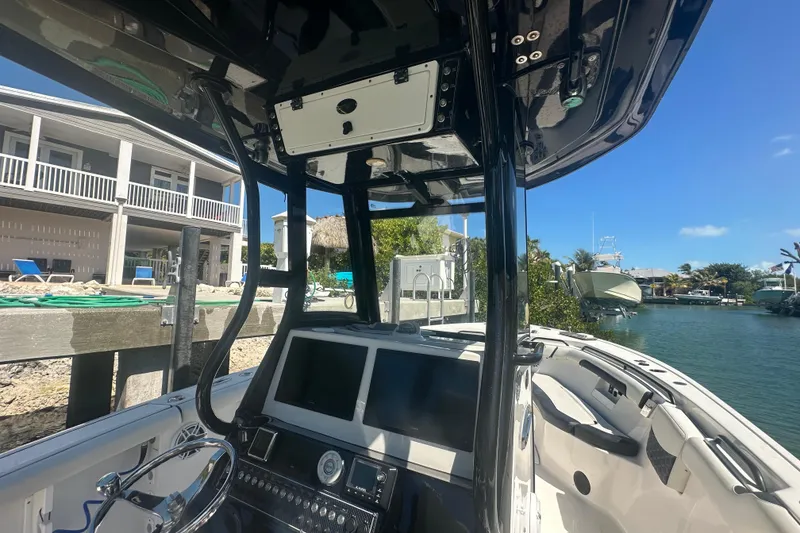 Slide: The Image of 2021 Tidewater 292 CC Adventure boat battery compartment with Dakota Lithium batteries. - 19