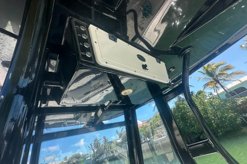 Slide: The Image of 2021 Tidewater 292 CC Adventure boat compartment with visible wiring and components. - 22