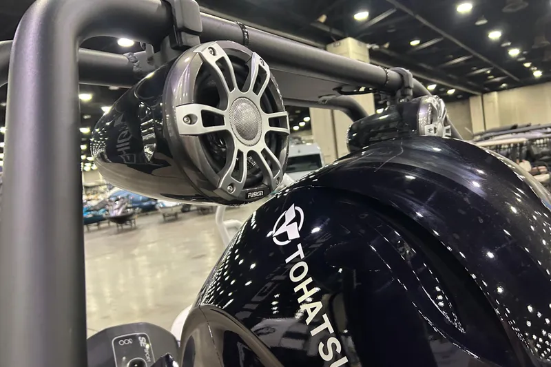 Slide: The Image of Highfield Sport 560 boat with Tohatsu engine and Fusion speakers, showcased indoors, 2026 model. - 11