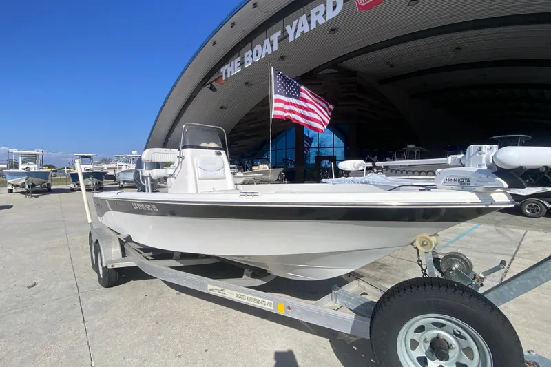 Slide: The Image of 2014 NauticStar 214 XTS Shallow Bay boat on trailer, American flag, at The Boat Yard. - 10