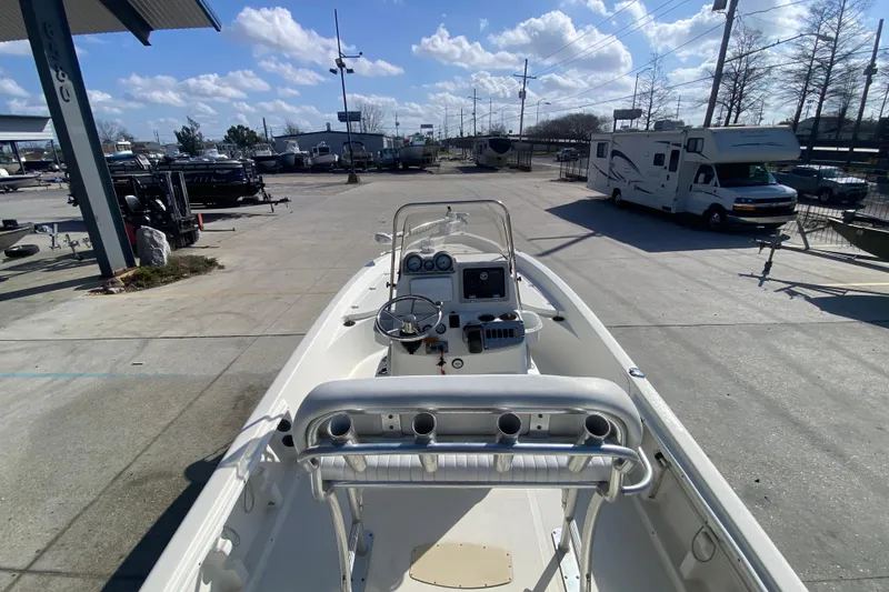 Slide: The Image of 2014 NauticStar 214 XTS Shallow Bay boat at a marina under a blue sky. - 11