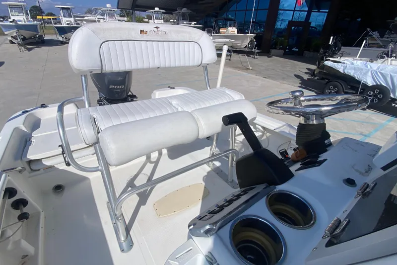 Slide: The Image of 2014 NauticStar 214 XTS Shallow Bay boat interior with steering wheel and seating. - 12