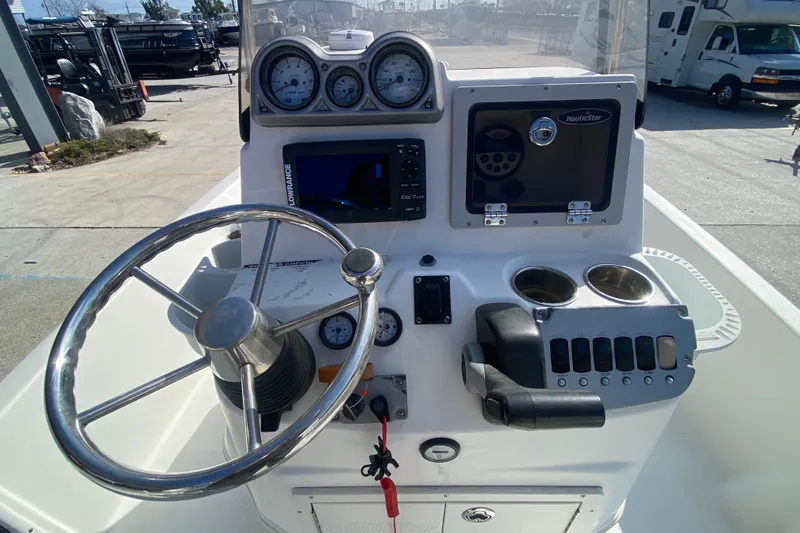 Slide: The Image of 2014 NauticStar 214 XTS Shallow Bay boat console with steering wheel and gauges. - 16