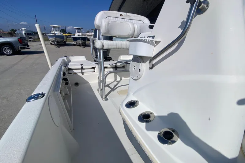 Slide: The Image of 2014 NauticStar 214 XTS Shallow Bay boat interior with seating and rod holders. - 17
