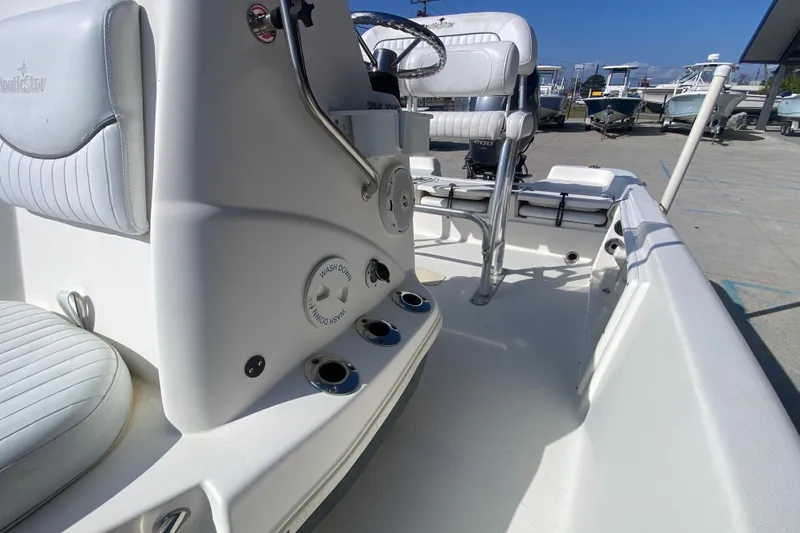 Slide: The Image of 2014 NauticStar 214 XTS Shallow Bay boat interior with seating and controls. - 18