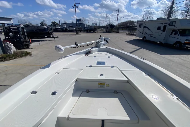 Slide: The Image of 2014 NauticStar 214 XTS Shallow Bay boat deck with trolling motor, parked outdoors. - 19
