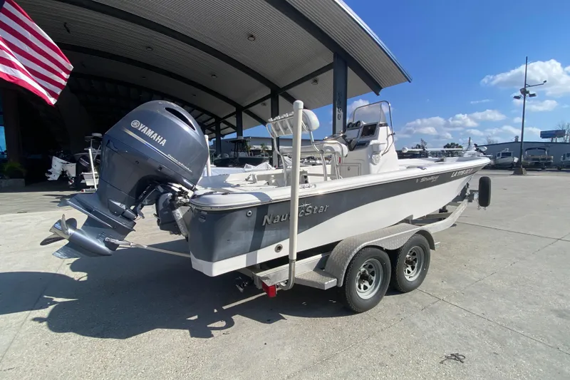 Slide: The Image of 2014 NauticStar 214 XTS Shallow Bay boat with Yamaha engine on trailer. - 4