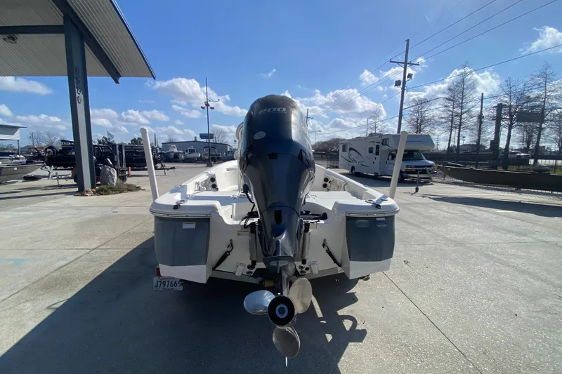 Slide: The Image of 2014 NauticStar 214 XTS Shallow Bay boat with outboard motor in a marina setting. - 5