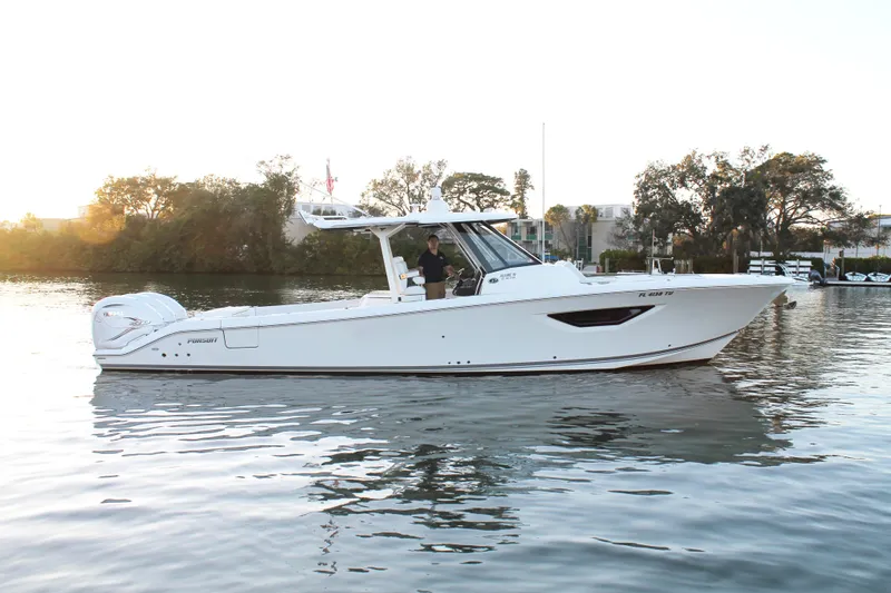 Slide: The Image of 2023 Pursuit S 378 Sport boat on calm water at sunset. - 10