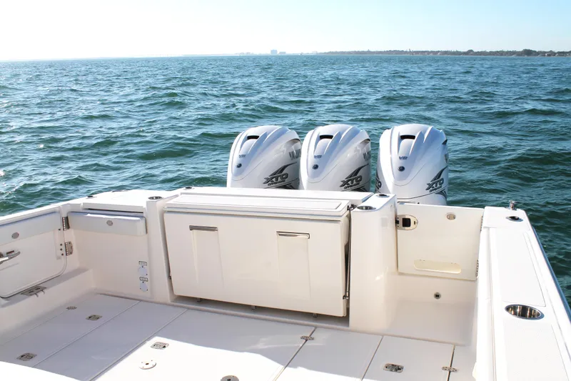 Slide: The Image of 2023 Pursuit S 378 Sport boat with triple outboard engines on open water. - 16